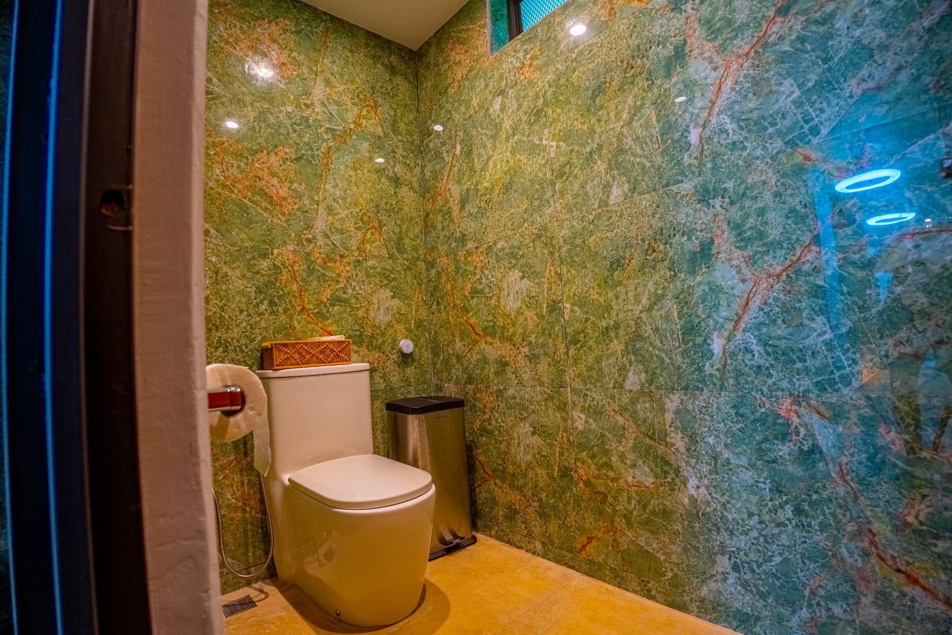 Powder room clad in green marble