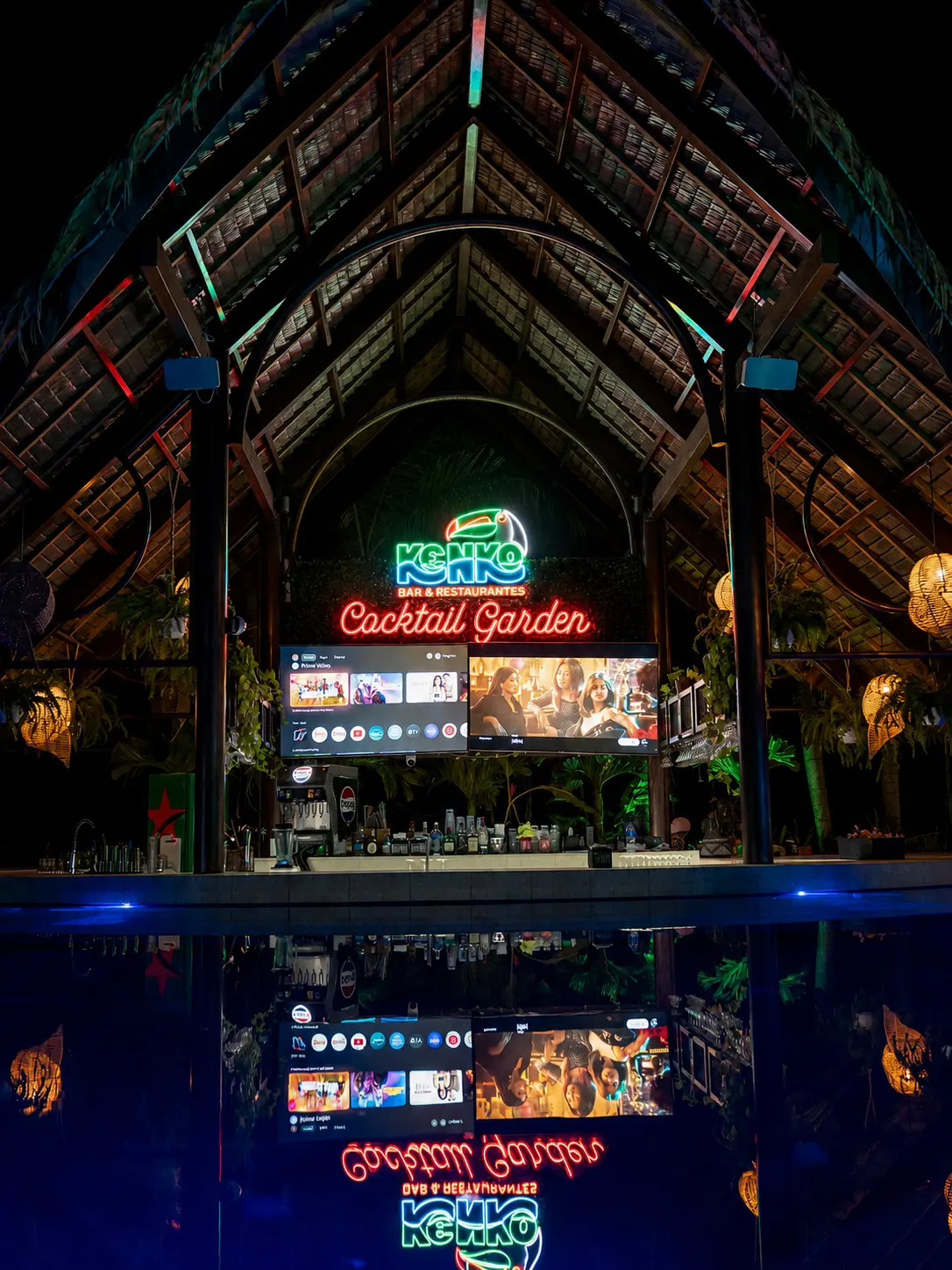 Kenko Cocktail Garden neon sign reflected in the pool at night