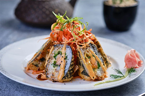 A plated sushi roll photographed for Kenko’s menu